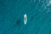 istock Aerial view of woman floating on a stand up paddle 1352716016