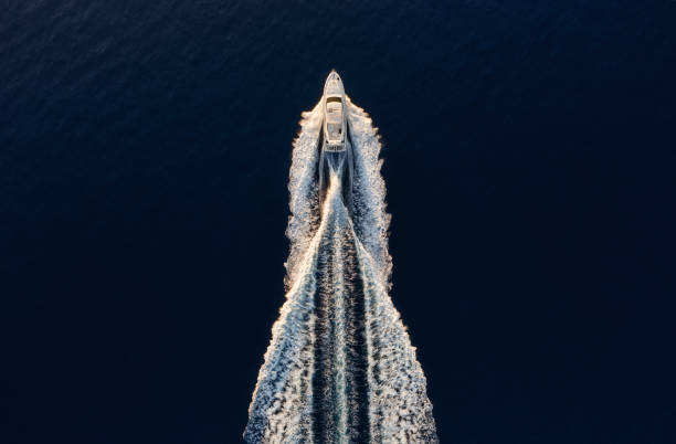 Aerial view on fast boat on blue Mediterranean sea at sunny day. Fast ship on the sea surface. Seascape from the drone. Seascape from air. Travel - image stock photo