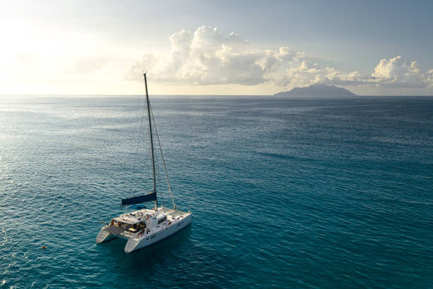 Aerial view on luxry sail yacht. Eco yacht catamaran sailing in ocean at sunset. Aerial view catamaran stock pictures, royalty-free photos & images