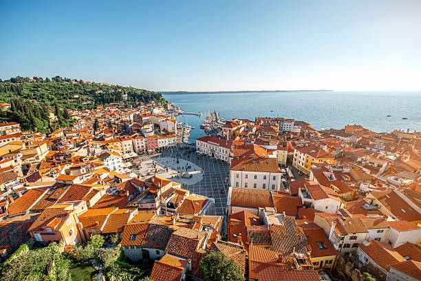 Aerial view on Piran town Beautiful aerial view on Piran town with Tartini main square, ancient buildings with red roofs and Adriatic sea in southwestern Slovenia slovenia stock pictures, royalty-free photos & images