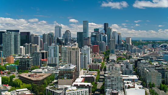 Aerial shot of Seattle, Washington on a sunny day in summer from over Lower Queen Anne, also referred to as Uptown, looking south along the Downtown waterfront.