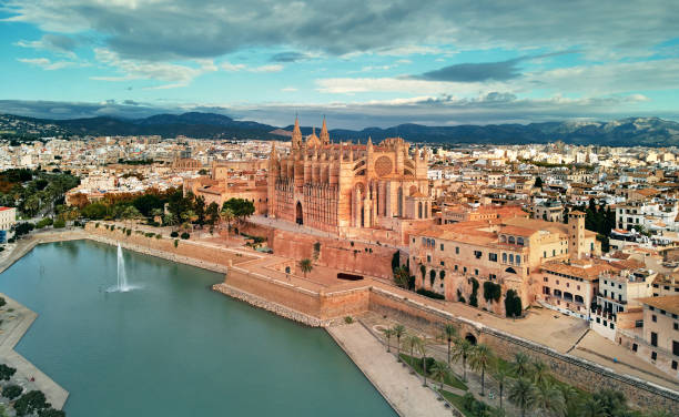Aerial view Palma de Mallorca Cathedral and cityscape. Spain Aerial drone view Palma de Mallorca Cathedral was built on a cliff rising out of the sea. Picturesque panorama Majorca cityscape mountain range cloudy sky residential buildings from top. Spain majorca stock pictures, royalty-free photos & images