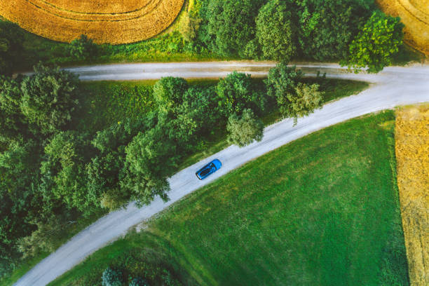 Aerial view road and field in Norway travel road trip drone scenery crossroads from above top down stock photo