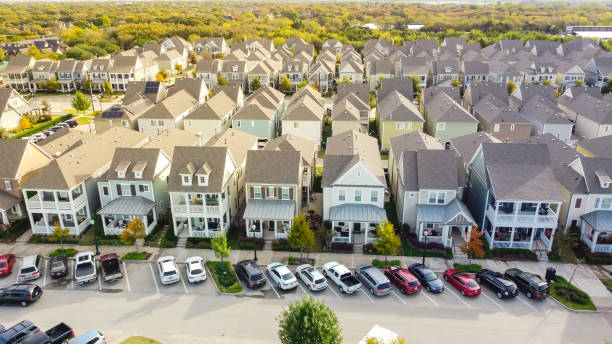 Aerial view row of upscale cottage style homes with parked cars on street near historic Old Town Coppell, Texas, USA stock photo