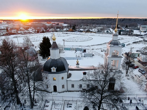 Aerial view the beautiful panoramic landscape of the ancient church against the background of winter nature at dawn on a freezing day in winter