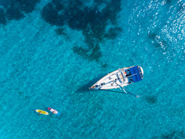 Aerial view to Yacht in deep blue sea. Drone photography stock photo