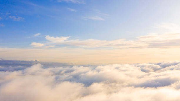 Aerial view White clouds in blue sky. Top view. View from drone. Aerial bird's eye view. Aerial top view cloudscape. Texture of clouds. View from above. Sunrise or sunset over clouds Aerial view White clouds in blue sky. Top view. View from drone. Aerial bird's eye view. Aerial top view cloudscape. Texture of clouds. View from above. Sunrise or sunset over clouds above stock pictures, royalty-free photos & images