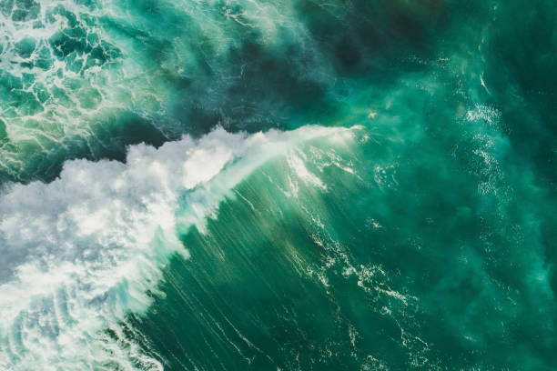Aerial wave background. Drone shot directly from above, green turquoise color, huge waves. Empty space stock photo