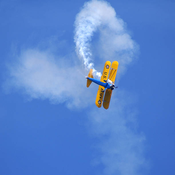 aerobatic stunt Stearman Kaydet biplane Biplane performing aerobatic stunt. Paint scheme of WWII Army Air Corp trainer. Stearman Kaydet. airshow stock pictures, royalty-free photos & images
