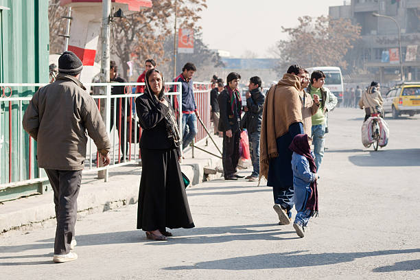 Afghan lady waiting to cross the street in Kabul stock photo