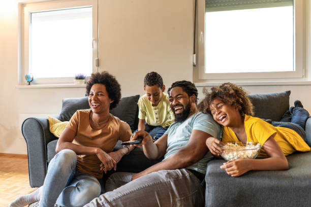 African American family watching a movie at home. stock photo