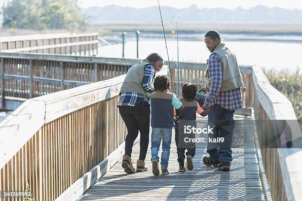 African American family with two boys going fishing