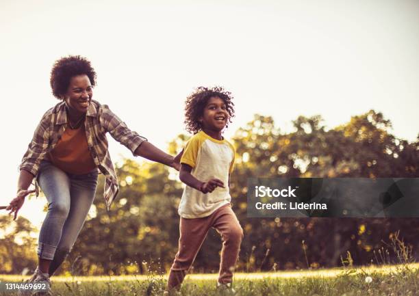 African American father and daughter having fun in the park.