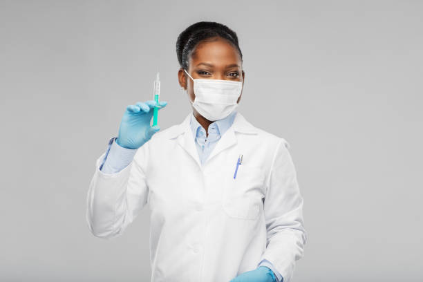 african american female doctor with syringe stock photo