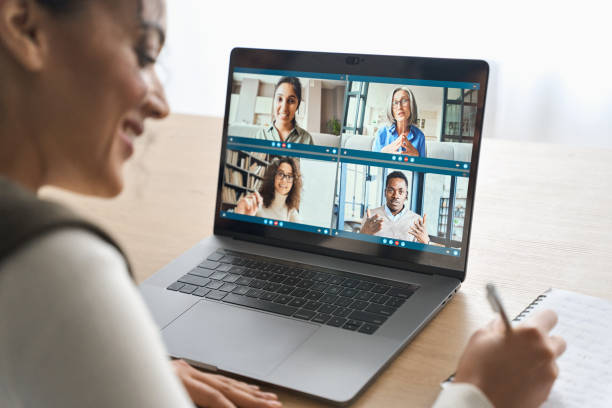 African American female student having video call videoconference on laptop.