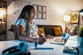 istock African American female student studying from home and taking notes from professor 1300822206