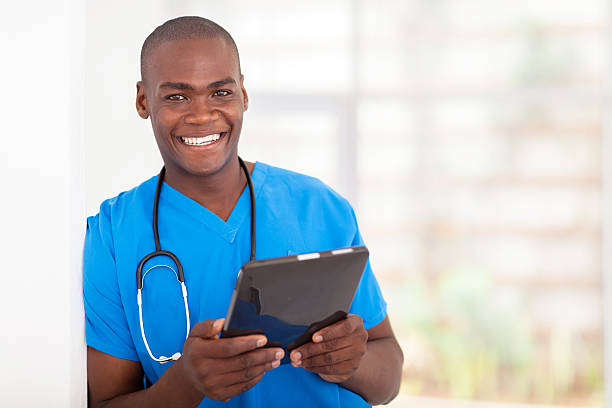 happy young african american health care worker with tablet computer