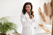 istock African American Lady Touching Hair After Shower Posing In Bathroom 1326400968