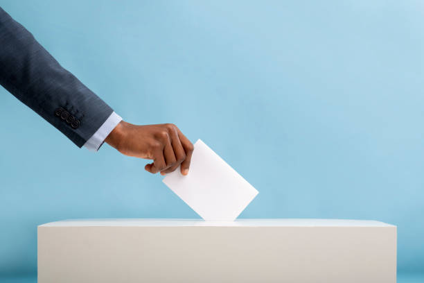 African american man voting for general election in United States US elections 2020 concept. African american man voting for general election in United States, blue background voting photos stock pictures, royalty-free photos & images