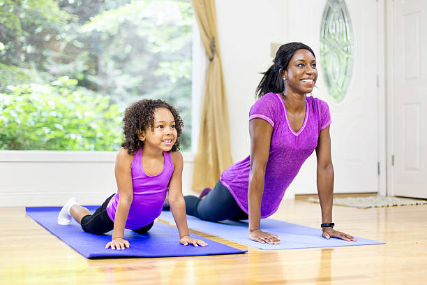 african-american-mother-and-daughter-doing-yoga-picture-id599270320?k=20&m=599270320&s=612x612&w=0&h=YFWndmxUA7f8kXls1Utl2YJIraOOztf3EKjvYiX7Wlw=