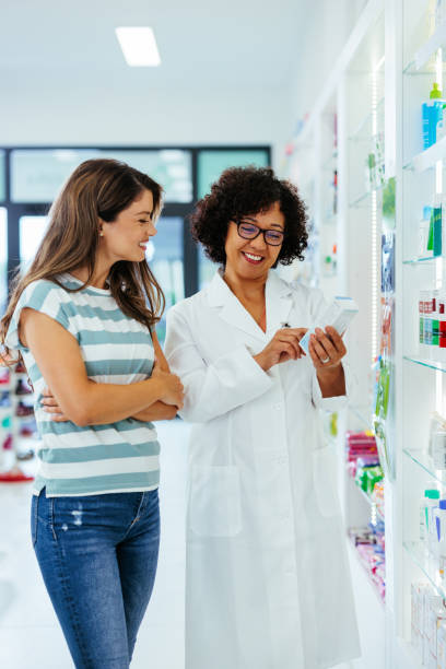 African american pharmacist assisting a customer stock photo