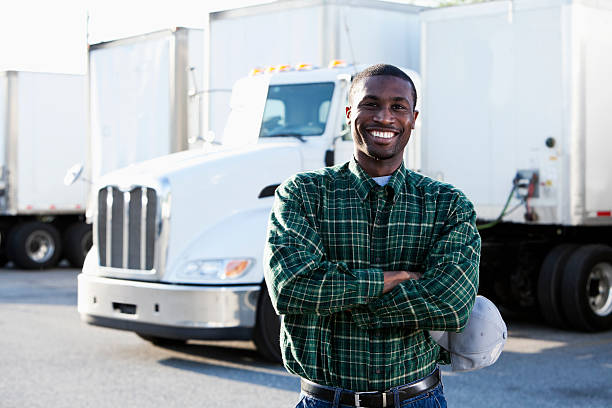 African American truck driver African American truck driver (20s) standing in front of semi-truck. truck driver stock pictures, royalty-free photos & images