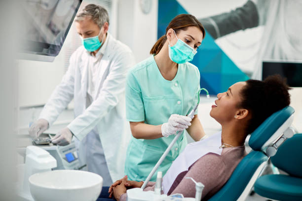African American woman having dental treatment at dentist's office. stock photo
