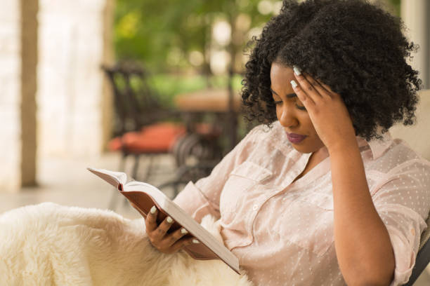 African American woman reading and upset. stock photo