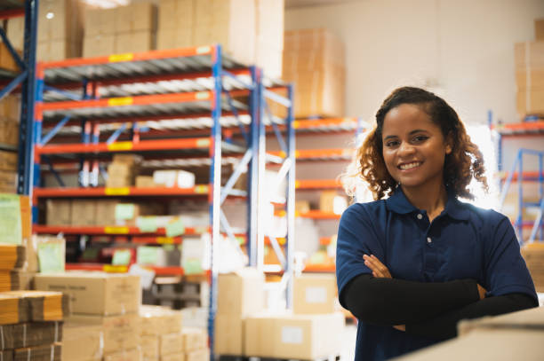 African American worker person working with safety in warehouse logistic factory, business manufacturing industry occupation concept, goods product box distribution stock photo