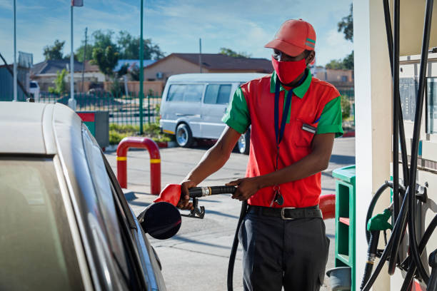 African attendant at a gas station stock photo