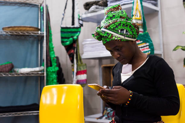 African business woman using an iphone at work stock photo