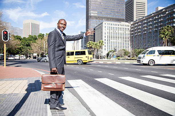African businessmen stopping a taxi stock photo