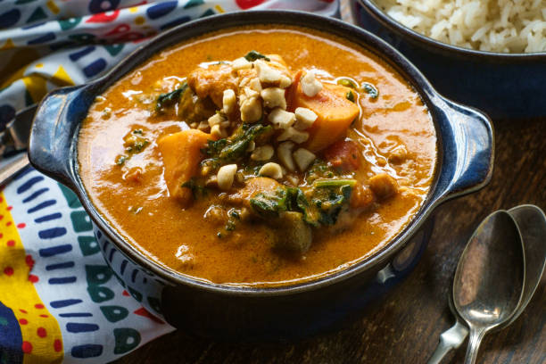 African Chicken Peanut Stew African chicken peanut stew with sweet potatoes and okra with side of basmati rice okra plants pics stock pictures, royalty-free photos & images
