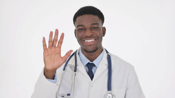 African Doctor Talking on Online Video Chat on White Background African American Doctor Talking on Online Video Chat on White Background nurse talking to camera stock pictures, royalty-free photos & images