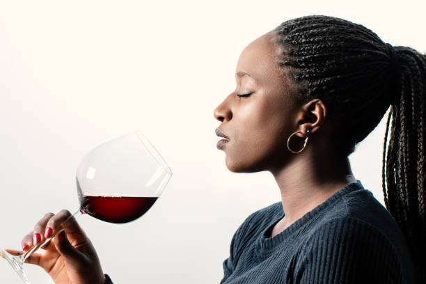 african female sommelier smelling red wine aroma. - sniffing glass imagens e fotografias de stock