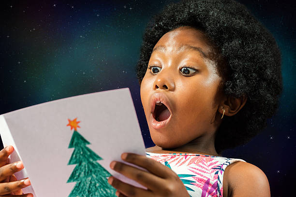 african-girl-reading-christmas-card-image-id626636890?k=20&m=626636890&s=612x612&w=0&h=PujFeItIEpgrIuszBZyvBo4E8UP_6p9Rv0Ep_g9eqj8=