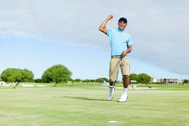 African golfer celebrating his win! stock photo
