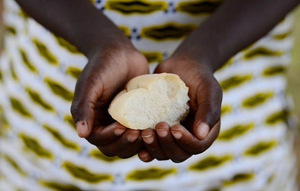 African Hands Cupped Holding Bread - Survival in Africa Symbol stock photo