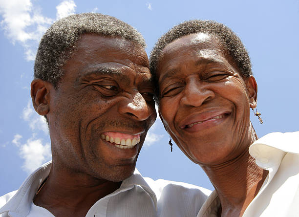 African Married Couple Laughing Married for a number of years now, this African couple demonstrate their love whilst sharing a joke together. old black couple in love stock pictures, royalty-free photos & images