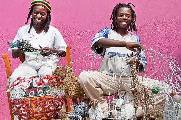African men designing and producing beadwork stock photo