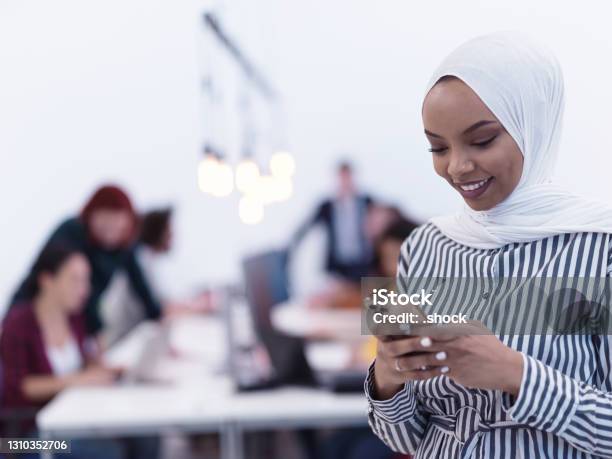 African muslim businesswoman at office using smart phone