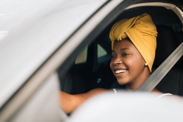 African woman driving a car stock photo