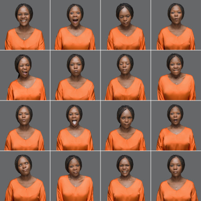 African woman making sixteen different facial expressions.Studio shot.