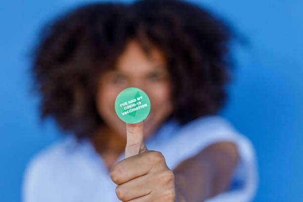 African Woman With COVID-19 Vaccine Sticker stock photo