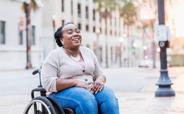 african-american woman with spina bifida - wheelchair street imagens e fotografias de stock
