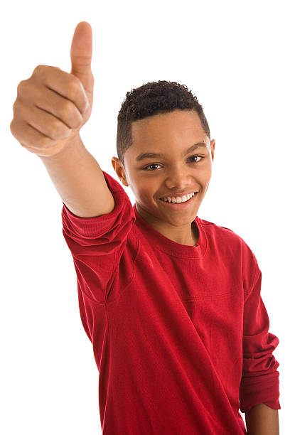 Africian ethnicity teenage boy gesturing thumbs up stock photo