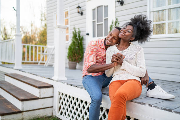 Afro couple in love hanging out on the porch stock photo