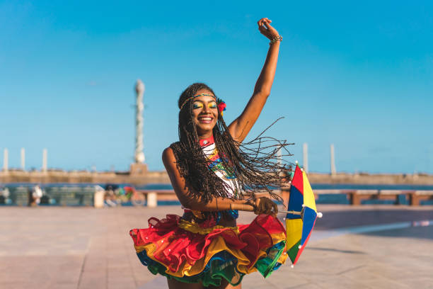 Afro dancer holding a Frevo umbrella in Marco Zero Frevo dance in Marco Zero, Recife city, Pernambuco state brazilian culture stock pictures, royalty-free photos & images