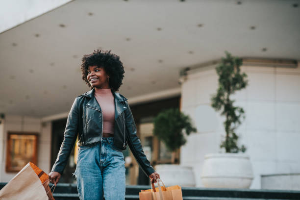 Afro female going from shopping stock photo