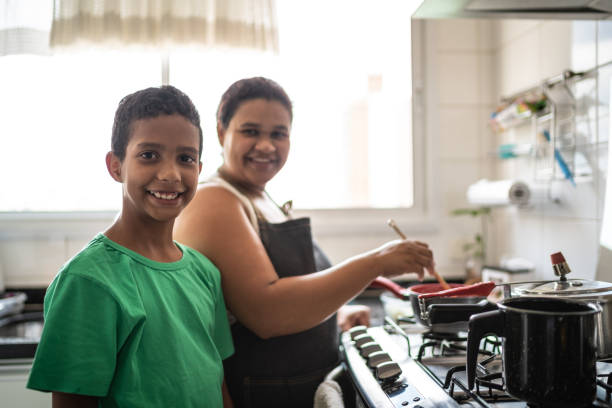 Afro latinx mother and son cooking at home portrait Domestic Life brazilian culture stock pictures, royalty-free photos & images